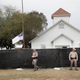 Police keep watch outside the First Baptist Church of Sutherland Springs in Texas after it was surrounded by a tarp on Nov. 9, 2017, in the wake of a fatal mass shooting there. (Scott Olson/Getty Images)